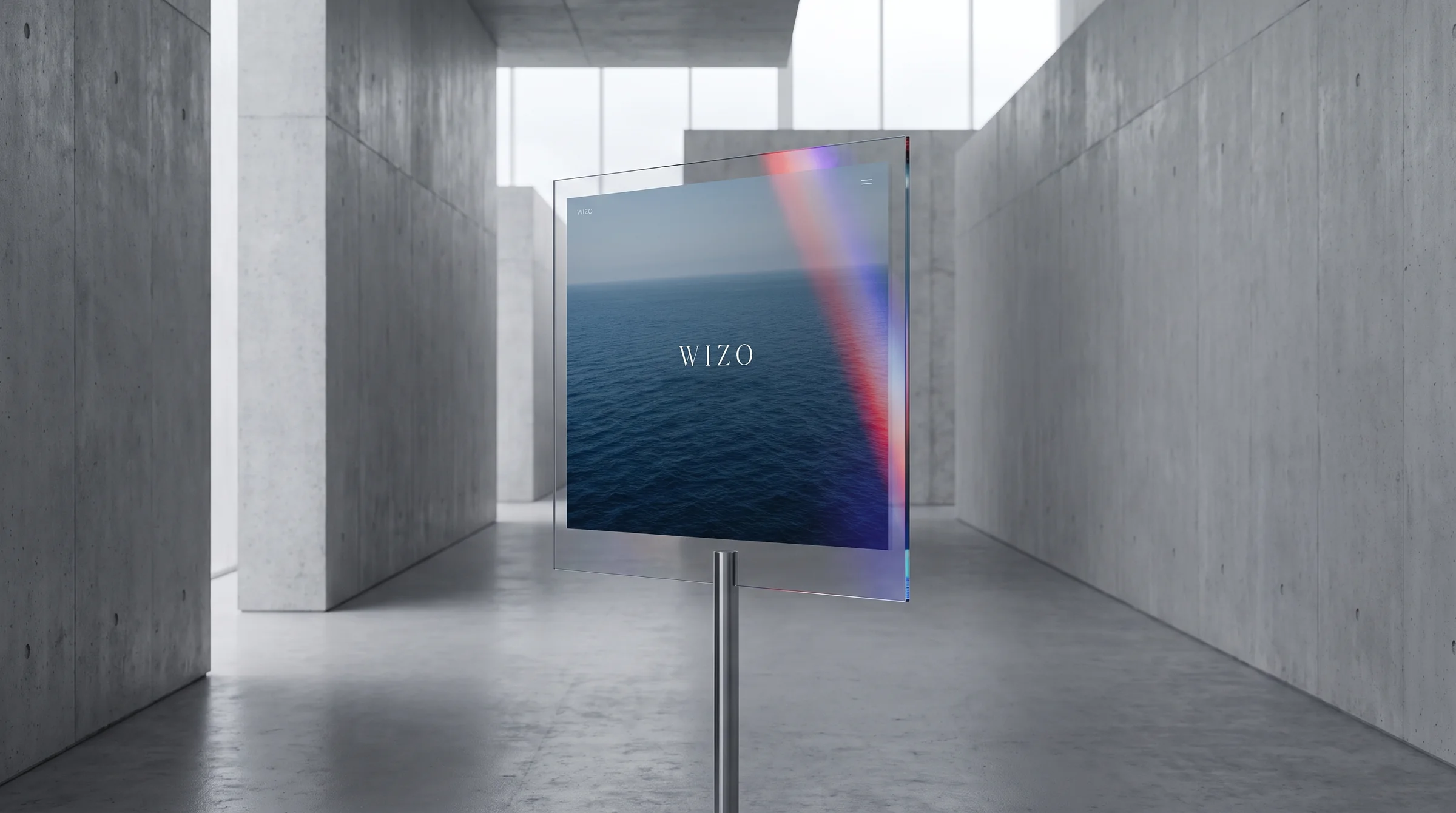A website shown on a thin glass screen in a concrete gallery.